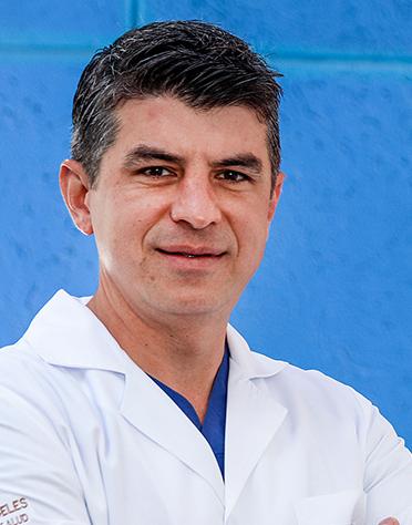 Es la foto de perfil de un ortopedista y traumatólogo en León de Hospital Angeles León. Usa una bata blanca, tiene los brazos cruzados y está sonriendo.